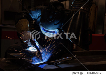 welder is welding metal part in car factory welder is welding metal part in car factory 106068076