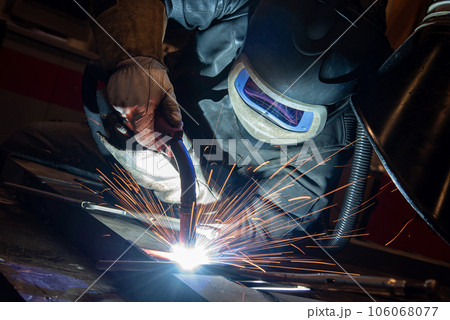 welder is welding metal part in car factory welder is welding metal part in car factory 106068077