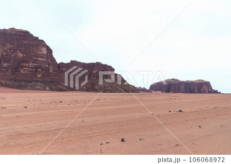 Planet Mars like landscape - Photo of Wadi Rum desert in Jordan with red pink sky above, this location was used as set for many science fiction movies Planet Mars like landscape - Photo of Wadi Rum desert in Jordan with red pink sky above, this location was used as set for many science fiction movies 106068972