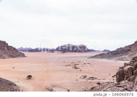 Planet Mars like landscape - Photo of Wadi Rum desert in Jordan with red pink sky above, this location was used as set for many science fiction movies Planet Mars like landscape - Photo of Wadi Rum desert in Jordan with red pink sky above, this location was used as set for many science fiction movies 106068978