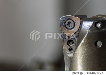 Close up scene the wear at the chip insert on indexable tool. 106069174