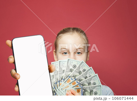 Young female model showing smartphone with blank empty white screen display and money cash Young female model showing smartphone with blank empty white screen display and money cash 106071444