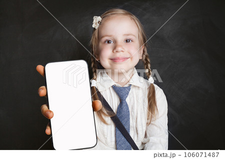 Cute young girl school student holding smartphone with blank empty white screen display 106071487