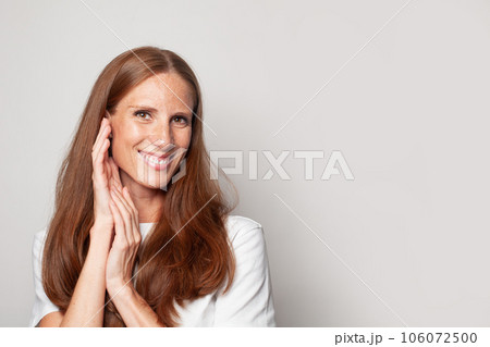 Portrait of happy smiling woman looking at camera on white background 106072500