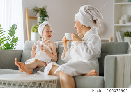 Mother and daughter after a bath 106072903