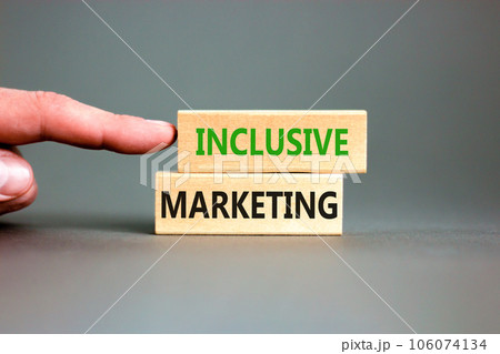Inclusive marketing symbol. Concept words Inclusive marketing on beautiful wooden block. Beautiful grey table grey background. Businessman hand. Business inclusive marketing concept. Copy space. 106074134