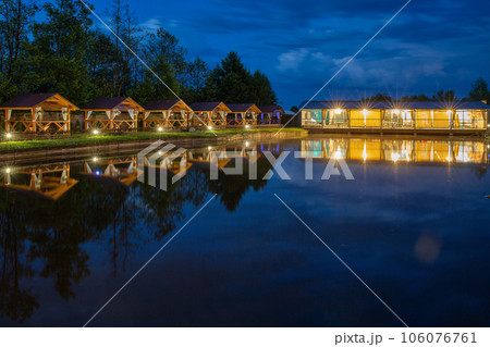 evening restaurant and wooden gazebos for relaxing by the lake 106076761