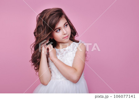 Close-up portrait of beautiful kid girl in dress looking away on pink background Close-up portrait of beautiful kid girl in dress looking away on pink background 106077141