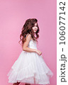 Beautiful little princess girl in white dress on pink background. Happy birthday 106077142