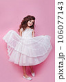 Full size body length little cute kid girl 5-6 years old wears pink dress dancing on pink background 106077143
