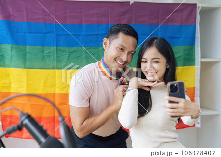 LGBTQIA friends taking selfies together with the Pride flag. LGBTQIA concept LGBTQIA friends taking selfies together with the Pride flag. LGBTQIA concept 106078407