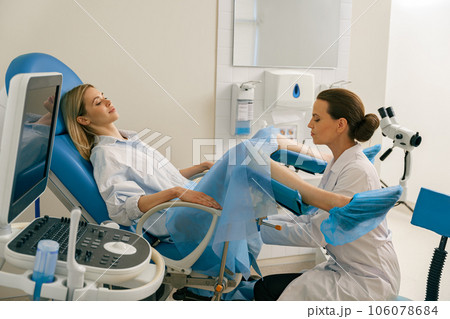 Young woman on appointment with her gynecologist during regular visit to women's consultation 106078684