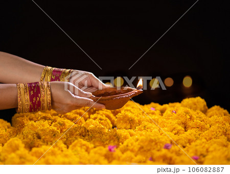 Happy Diwali - Diya lamps lit during diwali celebration 106082887