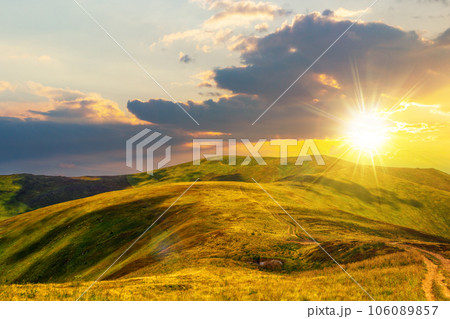 mountainous landscape at sunset. path through hill side to the mountain top. beautiful countryside scenery of ukrainian carpathians in evening light 106089857