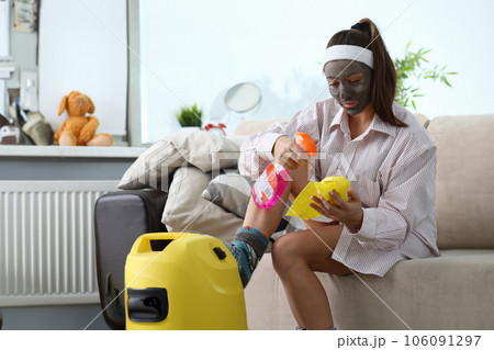 Girl with cosmetic mask on her face does cleaning 106091297