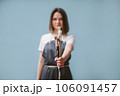 The artist holds brushes in her hands. Blurred background. 106091457