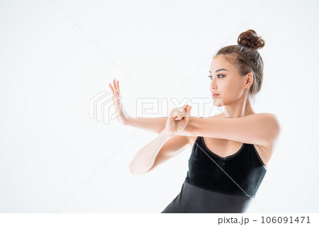 Beautiful sporty woman in black sportswear posing on white background with copy space. Beautiful sporty woman in black sportswear posing on white background with copy space. 106091471
