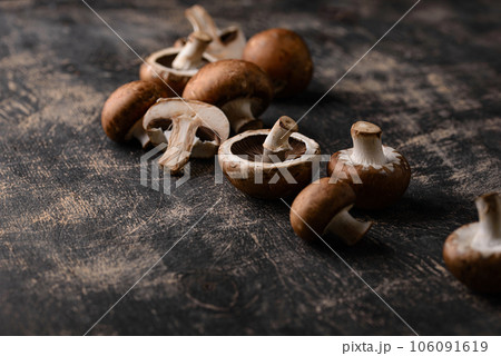 Raw champignon mushrooms on black background Raw champignon mushrooms on black background 106091619