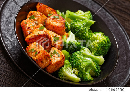 fried salmon bites with steamed broccoli florets fried salmon bites with steamed broccoli florets 106092304