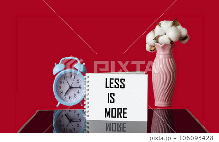 Text Less is more scale concept on red and black background. 106093428
