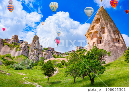 Cappadocia, Turkiye - July 07, 2023-Air balloons in Cappadocia-the ancient Uchisar Castle fortress. 106095501