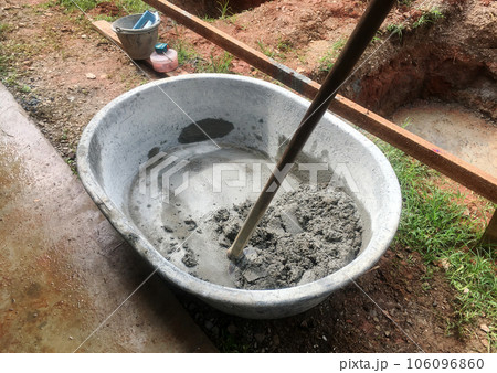 The mixing together to make a strong concrete floor. 106096860