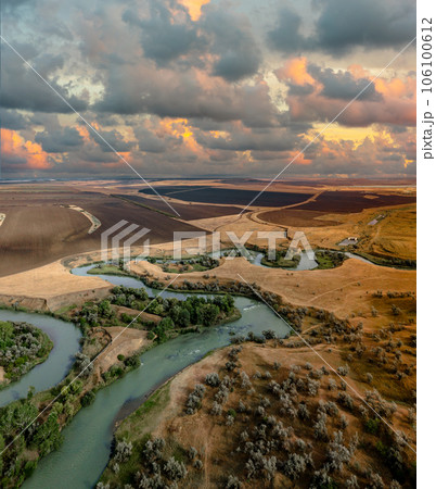 Summer scenery aerial view of winding river in beautiful valley at sunset 106100612