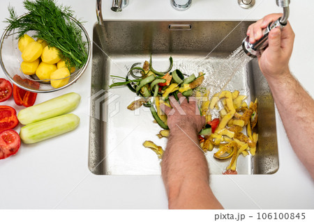 Modern sink with food waste in the hole of the disposer 106100845