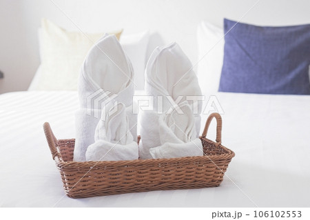 white cozy bedroom, decor idea and design, home interior decoration with towel set on top of the bed white cozy bedroom, decor idea and design, home interior decoration with towel set on top of the bed 106102553