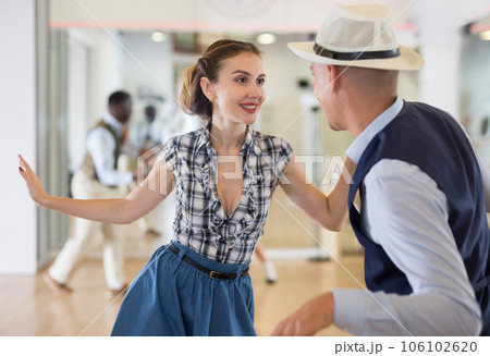 Woman and man dancing swing in studio Woman and man dancing swing in studio 106102620