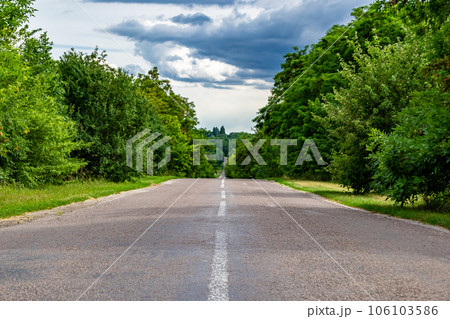Beautiful empty asphalt road in countryside on colored background 106103586
