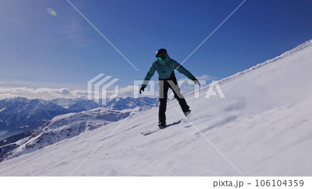 Snowboarder on piste in high mountains, freeze motion 106104359