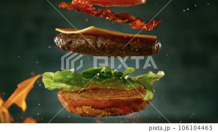 Beef Burger with Ingredients Falling and Landing in the Bun Beef Burger with Ingredients Falling and Landing in the Bun 106104463