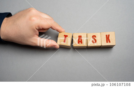 Task word concept. Business tasks and goal setting. Strategy and business management. Businessman holding wooden blocks Task word concept. Business tasks and goal setting. Strategy and business management. Businessman holding wooden blocks 106107108