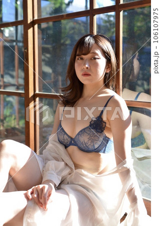 A young woman in underwear relaxing on the - Stock Photo [106107975] -  PIXTA