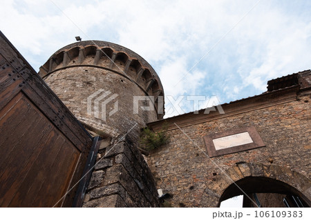 Ancient observation tower of a town in the Tuscan hills with cloudy sky in the background 106109383