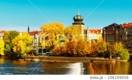 Ancient tower on the river bank in the fall. Autumn Prague. Landscape. 106109856
