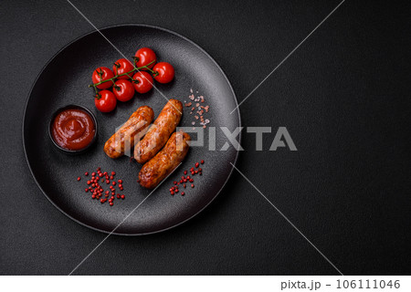 Delicious juicy grilled sausages with salt, spices and herbs 106111046