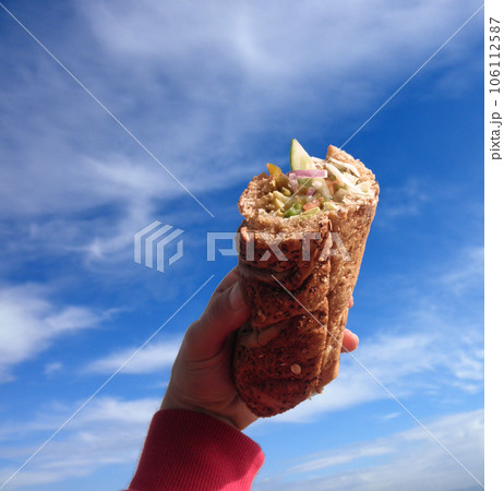 Fresh sub sandwich held up to the sky Fresh sub sandwich held up to the sky 106112587