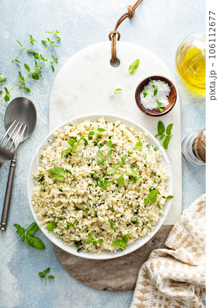 Cauliflower rice with herbs and lemon juice in a white bowl Cauliflower rice with herbs and lemon juice in a white bowl 106112677