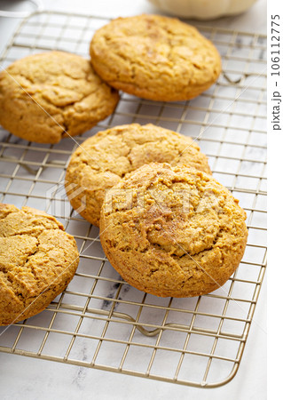 Soft pumpkin cookies on a cooling rack, fall baking Soft pumpkin cookies on a cooling rack, fall baking 106112775