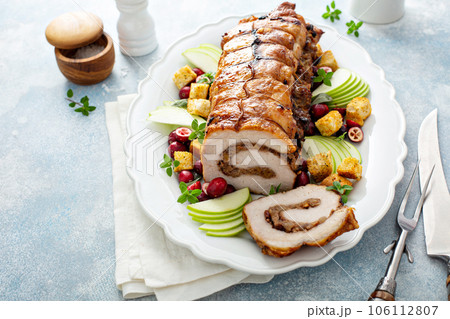 Roasted pork loin stuffed with apple and cranberry filling Roasted pork loin stuffed with apple and cranberry filling 106112807