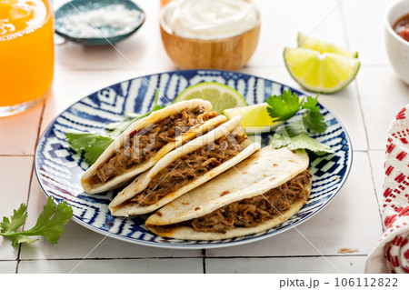 Baked tacos with Mexican Shredded Beef and cheese Baked tacos with Mexican Shredded Beef and cheese 106112822