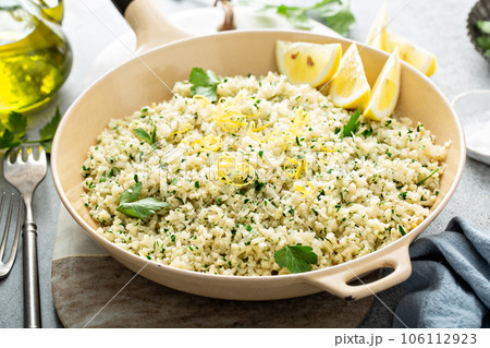 Lemon herb cauliflower rice cooked in a pan 106112923