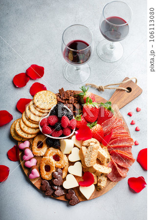 Cheese plate for Valentines day with snacks and fruit 106113080