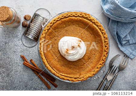Traditional pumpkin pie with whipped cream and cinnamon Traditional pumpkin pie with whipped cream and cinnamon 106113214