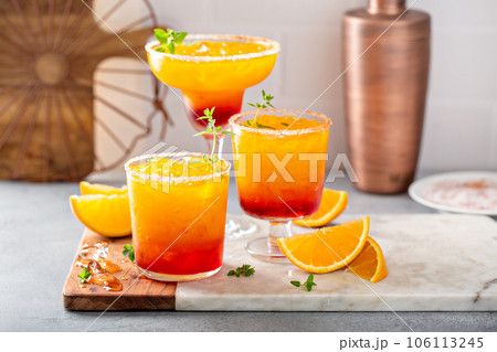 Tequila sunrise margarita cocktail with ice, refreshing drink 106113245
