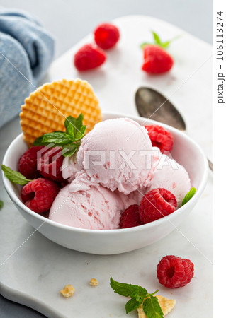 Raspberry ice cream in a bowl with fresh berries 106113274