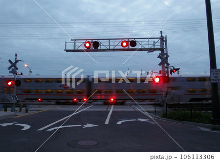 Train races by rail crossing at dusk Train races by rail crossing at dusk 106113306