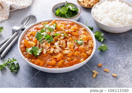 Vegan curry with cauliflower, chickpeas and butternut squash 106113380